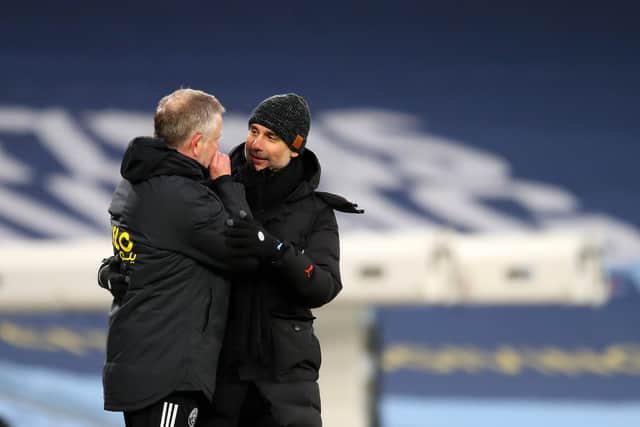Josep Guardiola and Chris Wilder talk after the final whistle at the Etihad Stadium: Darren Staples/Sportimage