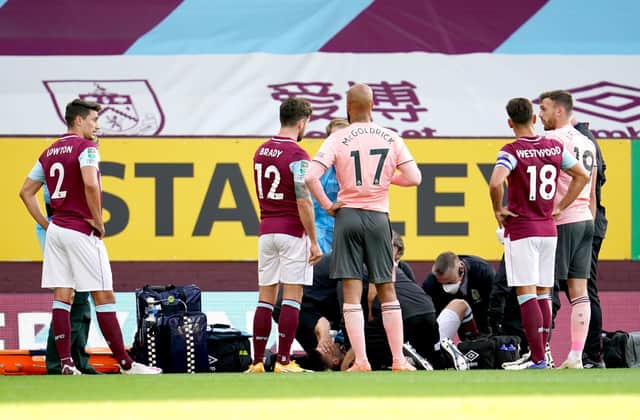 Burnley's Johann Berg Gudmundsson (floor) receives medical attention before being carried off the pitch on a stretcher: Jon Super/NMC Pool/PA Wire.