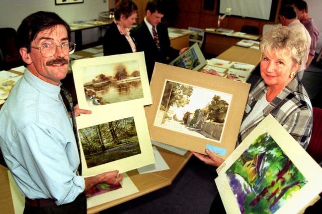 Artist David Curtis with Janet Conroy looking through artistic prints.
