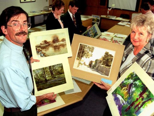 Artist David Curtis with Janet Conroy looking through artistic prints.