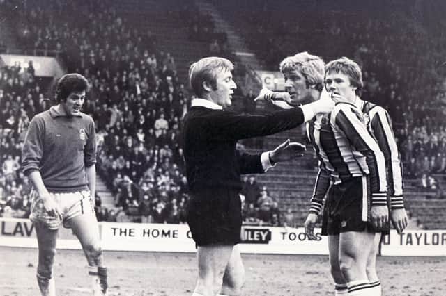 Alan Woodward has a chat with the referee during United's clash with Nottingham Forest in March 1977.