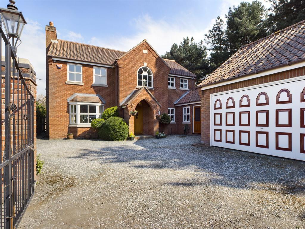 Front view of The Pines,  a driveway providing plenty off road parking and access to the double garage.