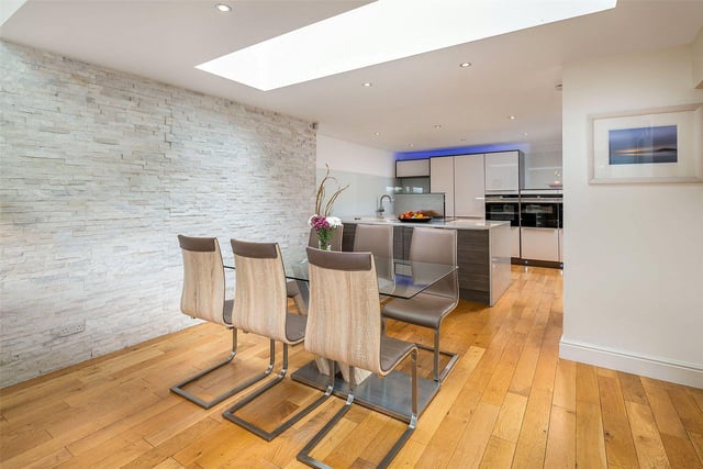 The open plan living space has a dining area next to the modern kitchen.