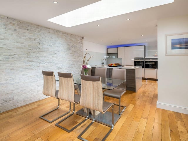 The open plan living space has a dining area next to the modern kitchen.