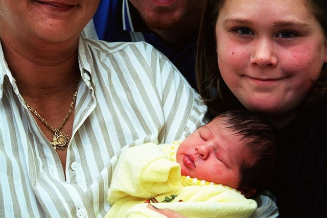 Jackie and Nick Prewett with their older daughter Jodie, aged 12, and baby Holly born at 9.35am on December 25, 1998 at the Jessop Hospital in Sheffield