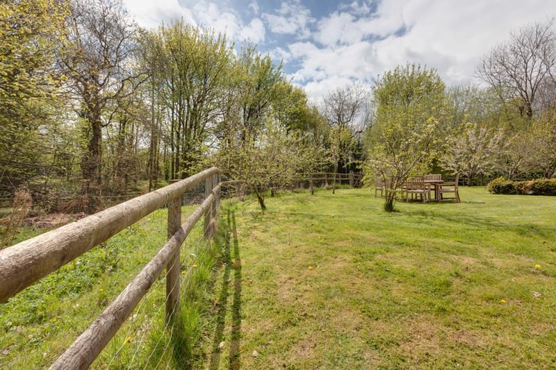 The property's 1.5 acre-plot includes a garden, orchard and paddock, with access to a woodland area and Birdholme Brook.
