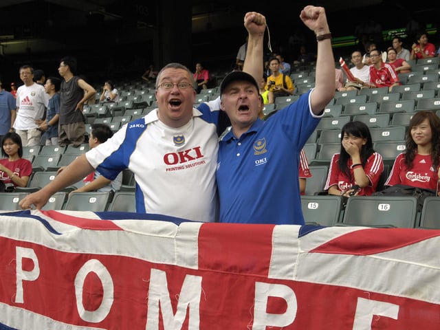 Jeff Rosier and Paul Banks, both from Portsmouth, cheer for Pompey in the Hong Kong Stadium.