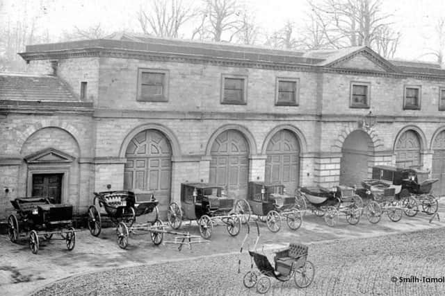 An array of carriages outside a wing of the stables in Wentworth Woodhouse, Rotherham in bygone times