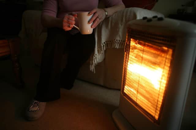 CONWY, UNITED KINGDOM - NOVEMBER 06:  In this photo illustration an old age pensioner keeps warm with the aid of an electric heater on November 6, 2008, in Conwy, Wales. With the recent high rise in fuel and energy bills many senior citizens are facing a cold winter. The UK's National pensioner Convention has called for a higher basic state pension for the over 60's.  (Photo by Christopher Furlong/Getty Images)