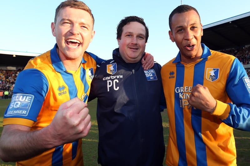 Paul Cox celebrates promotion with captain John Dempster and star striker Matt Green.