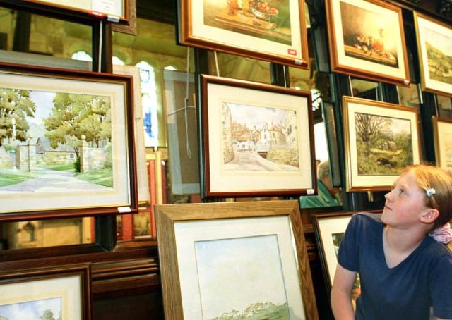 Ten year old Romy Poole admiring art in Hickelton church in 1999.