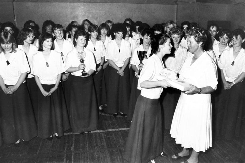 City of Sheffield Girls' Choir pictured after their return from Austria - Emily Cook, the choir's youngest member, makes a presentation to Vivien Pike in 1987
