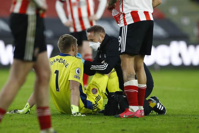 Sheffield United's goalkeeper Aaron Ramsdale receives medical assistance (Jason Cairnduff, Pool via AP)
