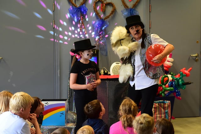 A magic show at the Family Summer Party with circus skills, stalls, crafts and an hour-long sponsored walk at The Place in the Park in 2018. Does this bring back memories?