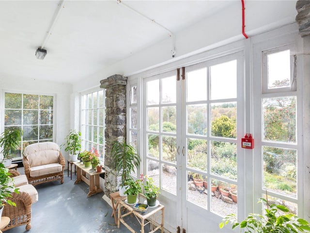 New owners can enjoy views of the garden from this sun room.