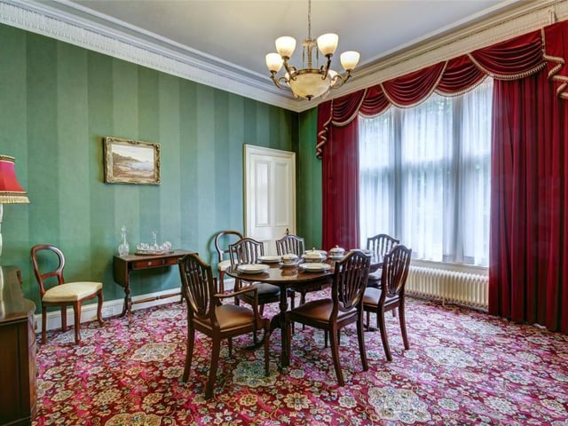 The dining room has large windows looking out over the garden.