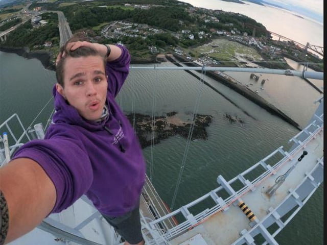 Adam Lockwood, 19, and three friends posed for selfies at the top of the structure, which towers around 500ft above the River Forth in central Scotland.
