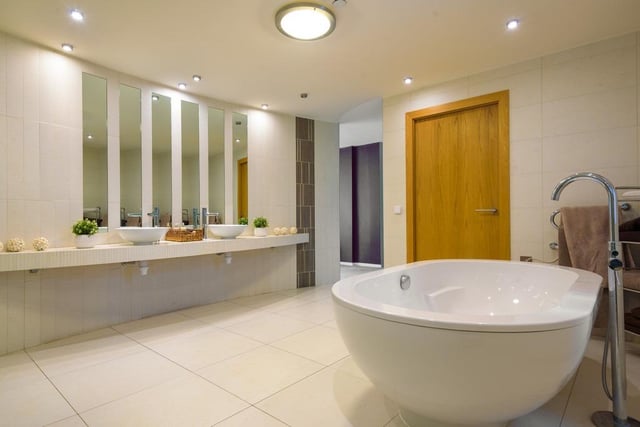 This stunning master en-suite has beautiful sinks, a standing bath and just behind where this picture was taken is a walk-in shower. It's the perfect modern bathroom for this ultra-modern home.