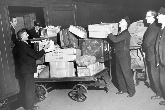 The scene on platform three of the Sheffield Victoria Railway Station as one of the night trains is loaded by members of the parcels department,  December 30,  1957