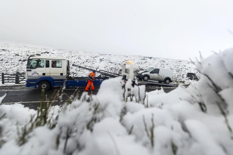 A crashed van is recovered on the Snake Pass as a blast of snow hit the north of England in November 2018