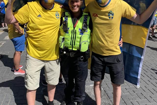 Sweden fans pose for pictures with police officers near the Sheffield Fan Zone