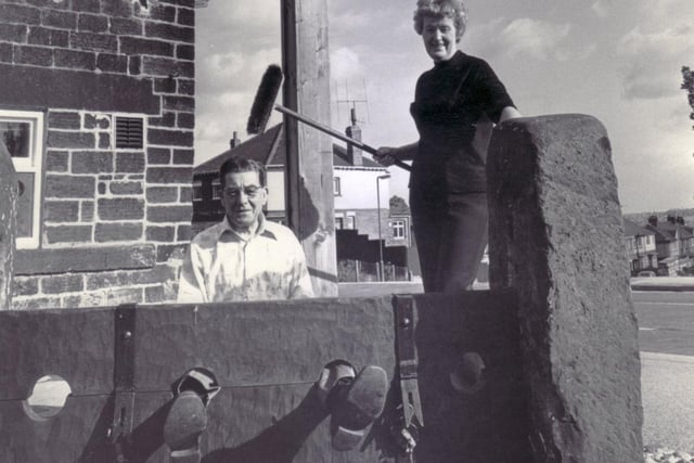 The stocks at Wadsley, returned to their orginal position, outside the Wadsley Jack pub (formerly The Star) in Rural Lane, Wadsley. In the stocks, at the mercy of his wife Ethel, is landlord, Jim Pulfrey, in October 1977 