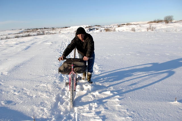 The snow steppe at Plains in Lanarkshire, winter 2010. Local man William Gault (55yrs old) travelled just under 2 miles in heavy snow, pushing his bike to and from an open cast mine to gather coal.
