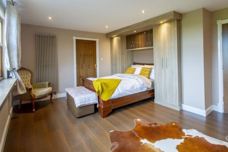 The main bedroom is all about style and comfort. There are built-in wardrobes, a vertical radiator and a window overlooking the front of the house.