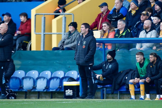 Mansfield Town manager Nigel Clough looks on.