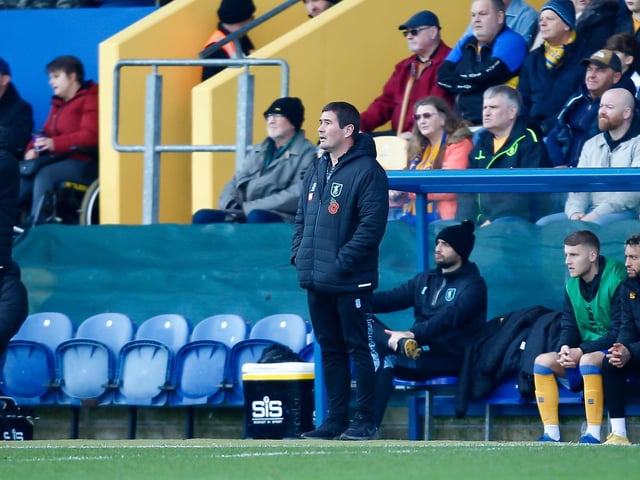 Mansfield Town manager Nigel Clough looks on.