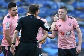 Sheffield United's John Lundstram protests his innocence after being sent off by referee Peter Bankes during his side's 1-1 draw at Brighton on Sunday. (Photo by MIKE HEWITT/POOL/AFP via Getty Images)