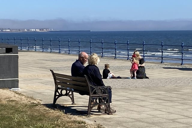 These visitors are able to keep their distance while having a breather on the promenade. Picture by FRANK REID