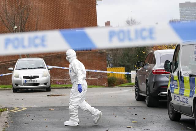 Forensics officers on Club Garden Road, Highfield, Sheffield, today. Picture Scott Merrylees