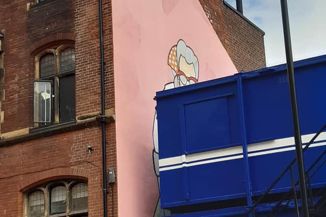 The Pete McKee mural, Muriel, covered up by builders' cabins on Carver Street. PIcture: Carol Benson