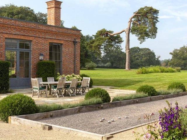 Luxurious extras are littered across the Baughurst House estate, including this petanque pitch. It is part of a French-style courtyard garden that sits outside an additional guest-cottage on the estate, known as the Coach House, and can be lit up at night as an entertaining space. Nearby is a hard tennis court.