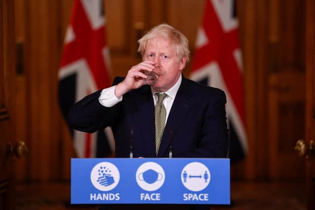 Prime Minister Boris Johnson drinks water during a media briefing in Downing Street, London, on coronavirus (COVID-19).