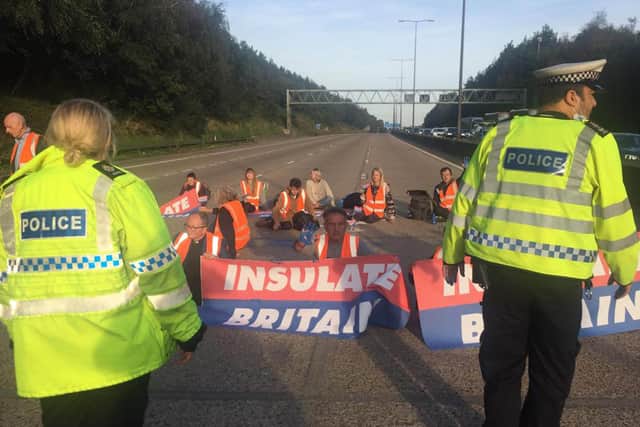 Handout photo issued by Insulate Britain of protesters occupying the clockwise and anti-clockwise lanes on the M25 in Surrey this morning. Issue date: Tuesday September 21, 2021.