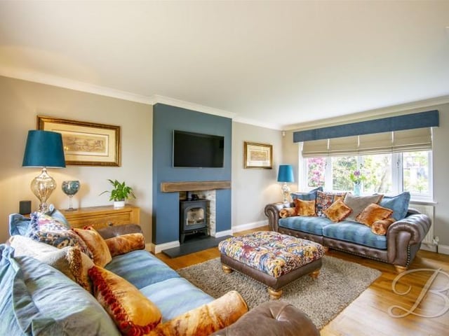 The focal point of this room is the feature fireplace housing a log burner.