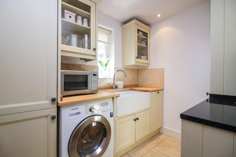The utility room to the rear provides useful storage space and has an integrated fridge freezer and Belfast sink.