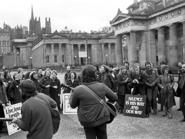 Followers of the Indian cult leader Bhagwan Shree Rajneesh singing and dancing at The Mound in Edinburgh in January, 1983.