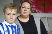 Sheffield Wednesday fan Kerrie Footitt, pictured with her son Jack. She was upset after being wrongly accused of taking a player's shirt during a match, but she has since accepted the club's apology. Picture Scott Merrylees
