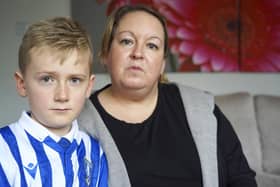 Sheffield Wednesday fan Kerrie Footitt, pictured with her son Jack. She was upset after being wrongly accused of taking a player's shirt during a match, but she has since accepted the club's apology. Picture Scott Merrylees