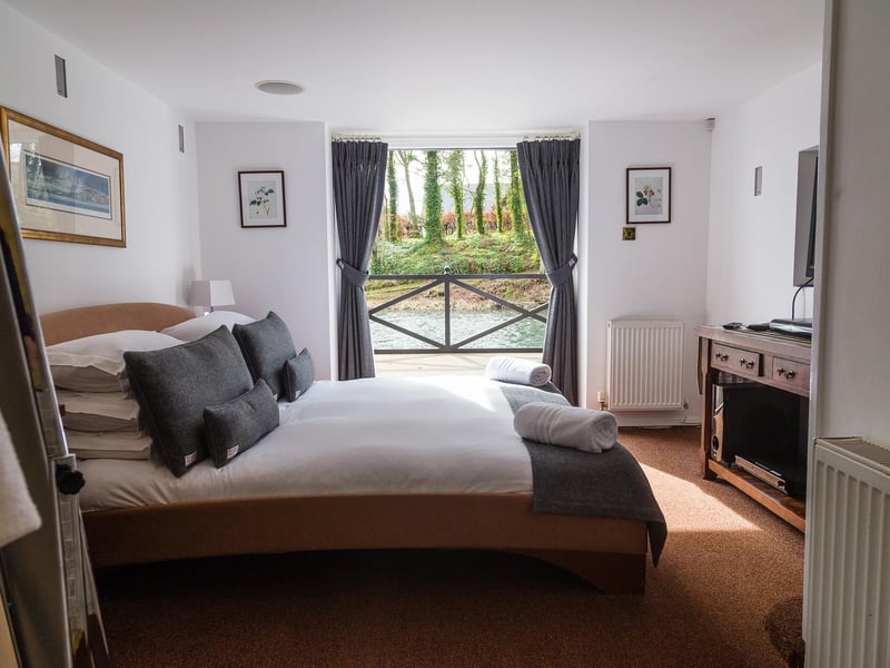 A bespoke kingsize bed with a view over the water ensures you'll have a great night's sleep.