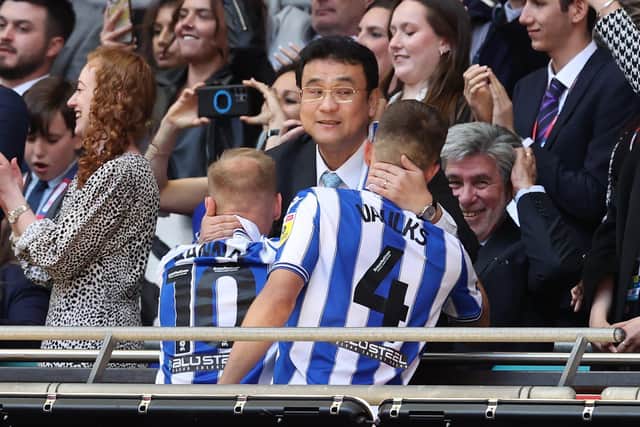 Sheffield Wednesday owner Dejphon Chansiri hugs Barry Bannan of Sheffield Wednesday and Will Vaulks of Sheffield Wednesday during the Sky Bet League 1 match at Wembley Stadium, London. David Klein / Sportimage