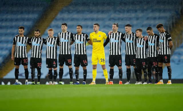 MANCHESTER, ENGLAND - DECEMBER 26: Newcastle United players stand for a minutes silence to remember the lives lost this year associated with football prior to the Premier League match between Manchester City and Newcastle United at Etihad Stadium on December 26, 2020 in Manchester, England. The match will be played without fans, behind closed doors as a Covid-19 precaution. (Photo by Clive Brunskill/Getty Images)