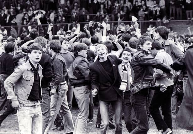 Jubilant United fans on the pitch when they mistakenly think United have not gone down after the Sheffield United v Walsall match on May 2, 1981