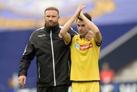 Former Sheffield Wednesday midfielder Kieran Lee leaves the pitch with his Bolton Wanderers manager Ian Evatt.