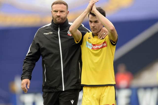 Former Sheffield Wednesday midfielder Kieran Lee leaves the pitch with his Bolton Wanderers manager Ian Evatt.