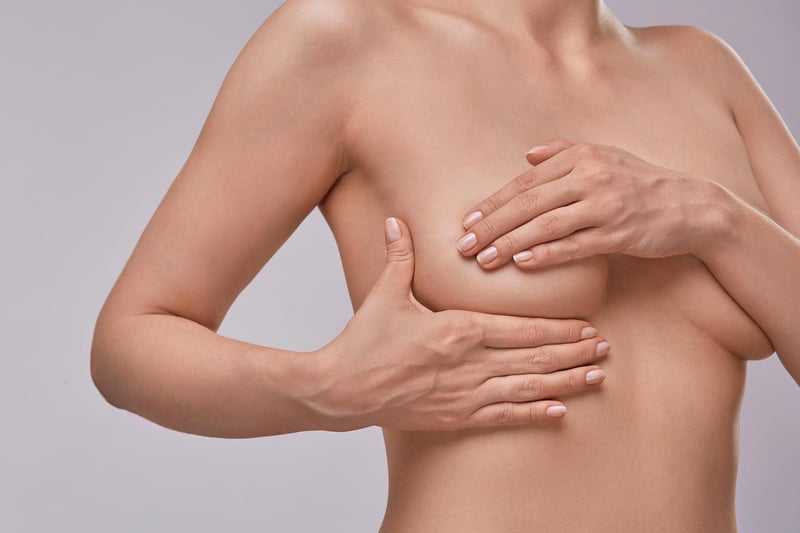 A rare type of breast cancer called inflammatory breast cancer can have different symptoms, causing the breast to appear red and inflamed. It might feel hard to the touch and the skin may have an orange peel texture and feel sore. You should see your doctor if you experience these symptoms.
