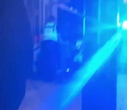 Grainy footage shows police officers at the scene.